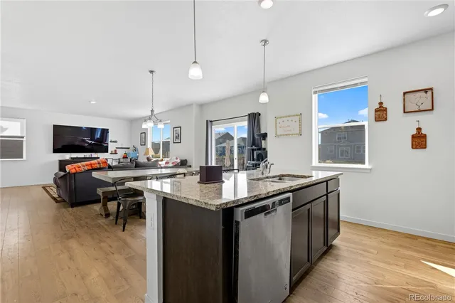 a kitchen with stainless steel appliances kitchen island a cabinets and wooden floor