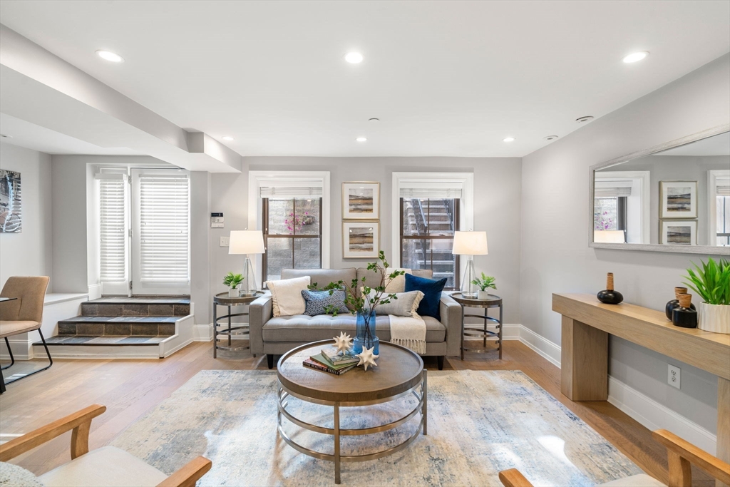 a living room with furniture and a wooden floor