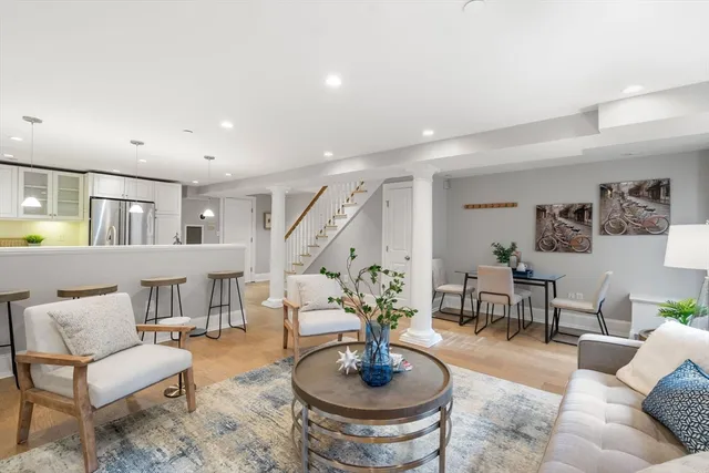 a living room with furniture and a dining table