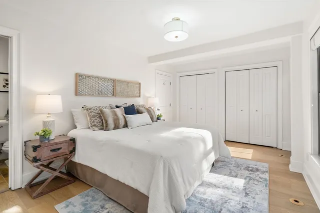 a bedroom with a bed and a potted plant