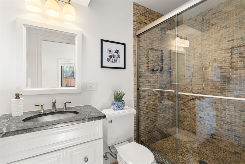 8 Concord Square, Unit 1 Boston, MA 02118 - Photo 6 of 11 a bathroom with a granite countertop sink toilet and shower