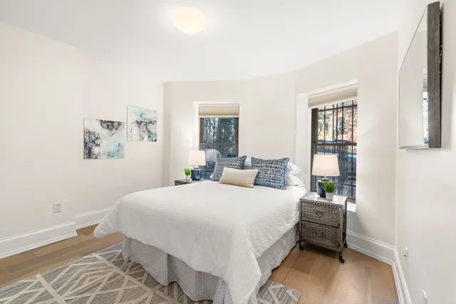 a bedroom with a bed and a night stand