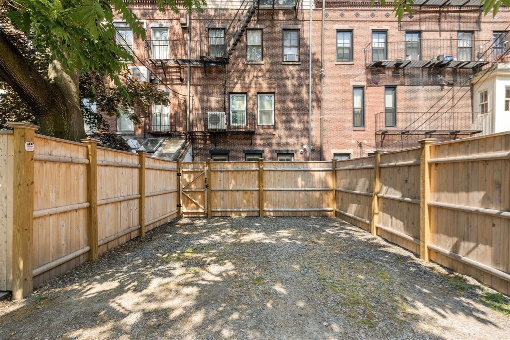 8 Concord Square, Unit 1 Boston, MA 02118 - Photo 10 of 11 a view of a building with wooden fence