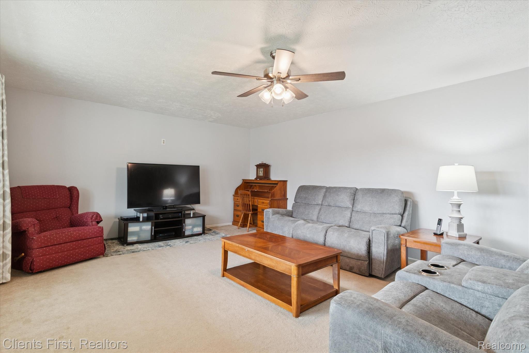 6550 Hitchingham Road Ypsilanti, MI 48197 - Photo 6 of 53 Carpeted living area featuring a ceiling fan and a textured ceiling