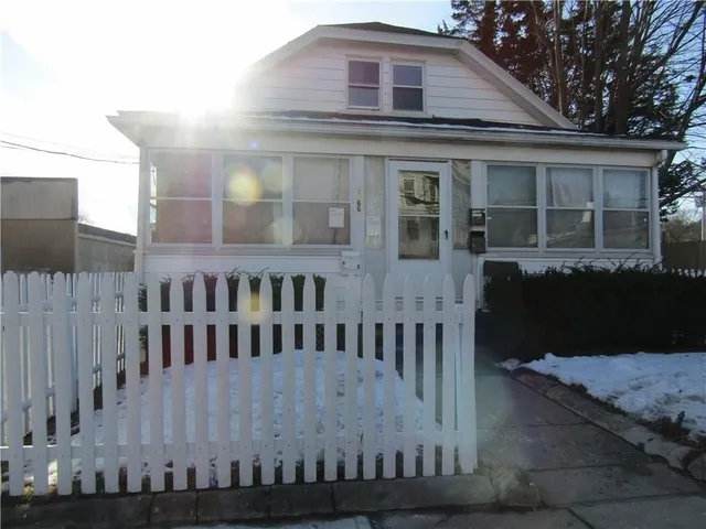 a view of a house with wooden fence