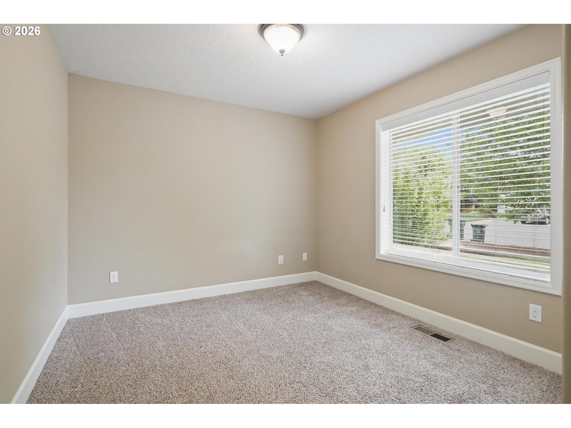 1075 Sage Street Silverton, OR 97381 - Photo 6 of 46 a view of an empty room with a window