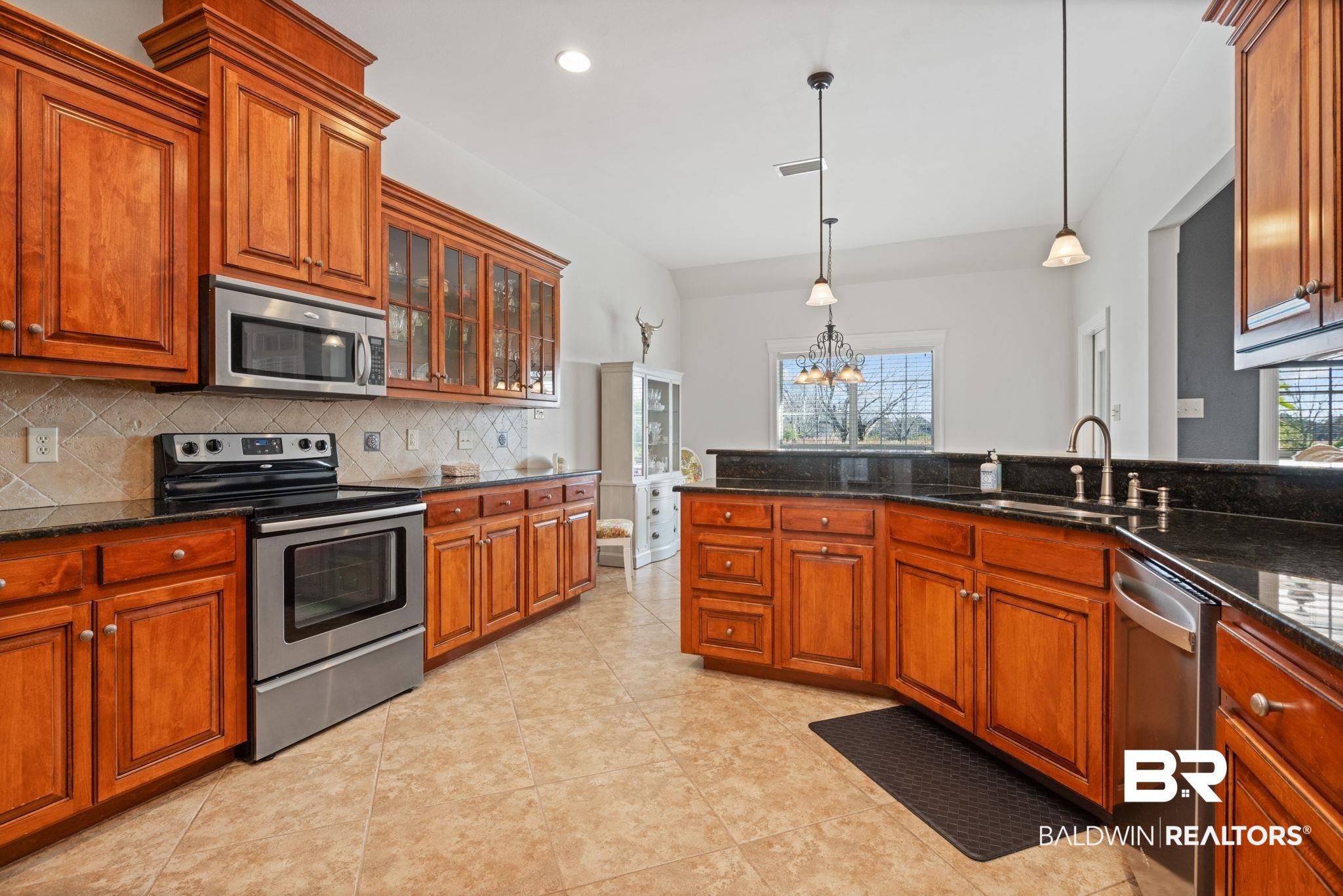 4771 Pecan Ridge East Mobile, AL 36619 - Photo 25 of 48 Kitchen featuring stainless steel appliances, brown cabinetry, dark stone countertops, pendant lighting, and recessed lighting