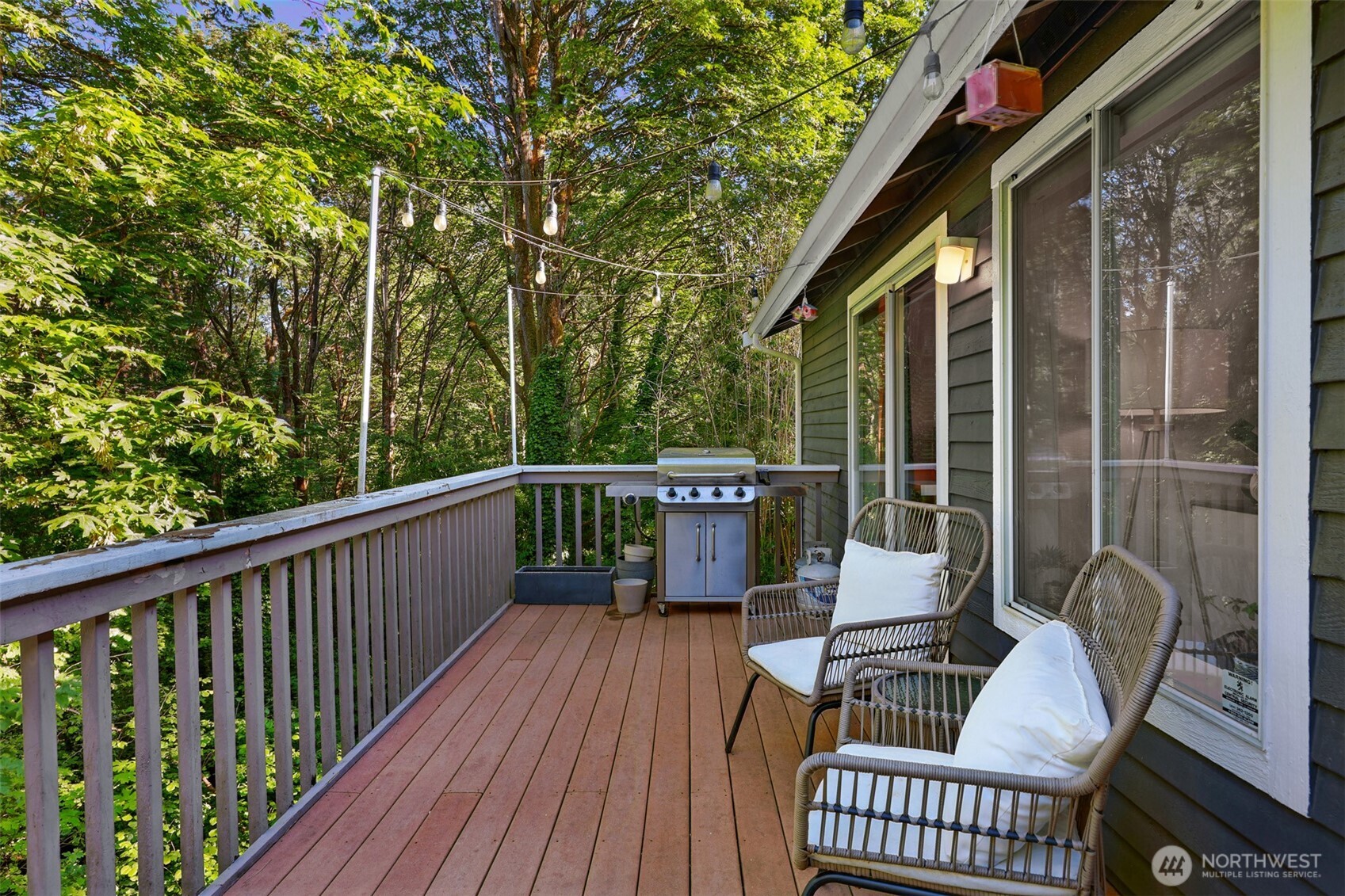 5126 South Garden Loop Road, Unit 11 Seattle, WA 98118 - Photo 14 of 36 a view of a deck with two chairs and wooden floor