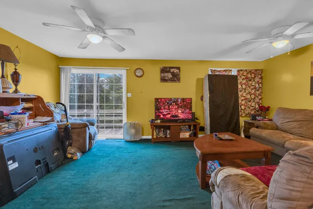 a view of a livingroom with workspace and a window
