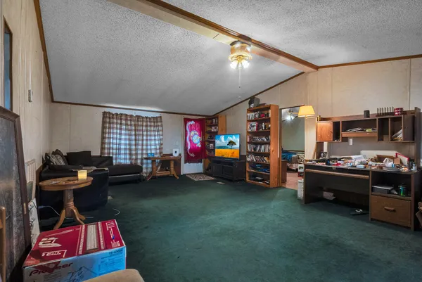 a living room with lots of furniture and a flat screen tv