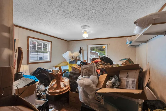 a living room with furniture a window and a flat screen tv