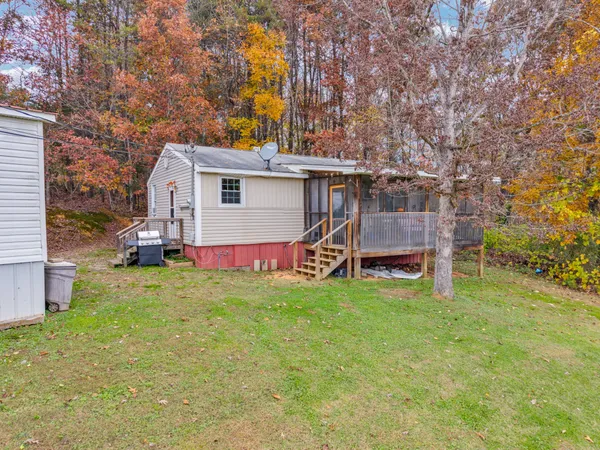 a house view with swimming pool and trees in the background
