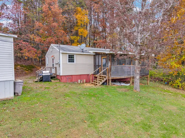 a house view with swimming pool and trees in the background