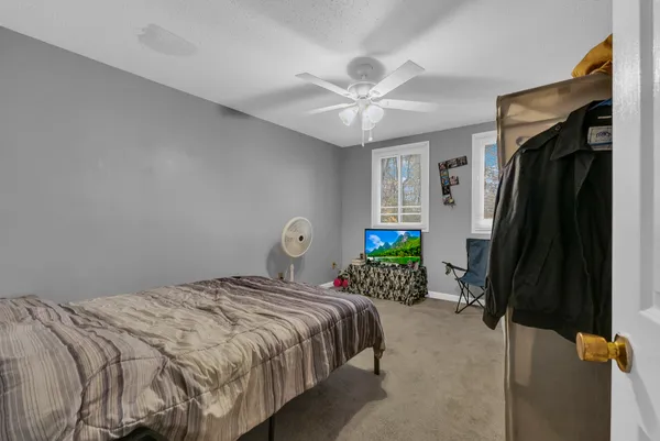 a bedroom with a bed table and a window