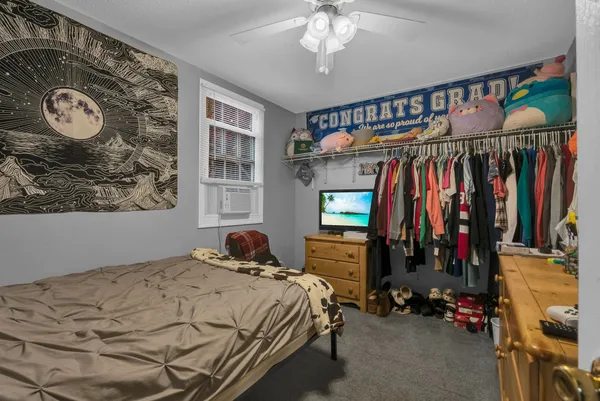a bedroom with a bed and a chandelier