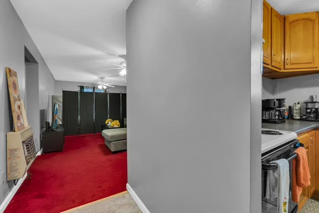 a hallway with sliding door and yellow appliances