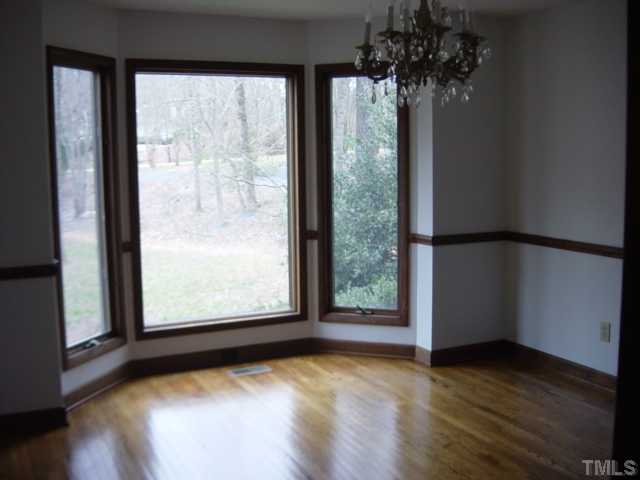 Formal dining room with hardwood floors. Beautiful view from bay window.