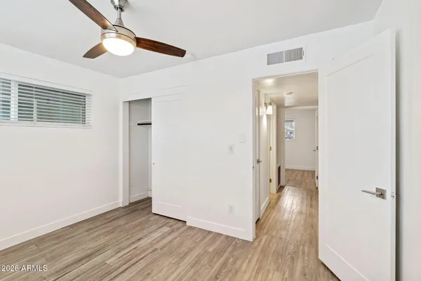 a view of an empty room with wooden floor