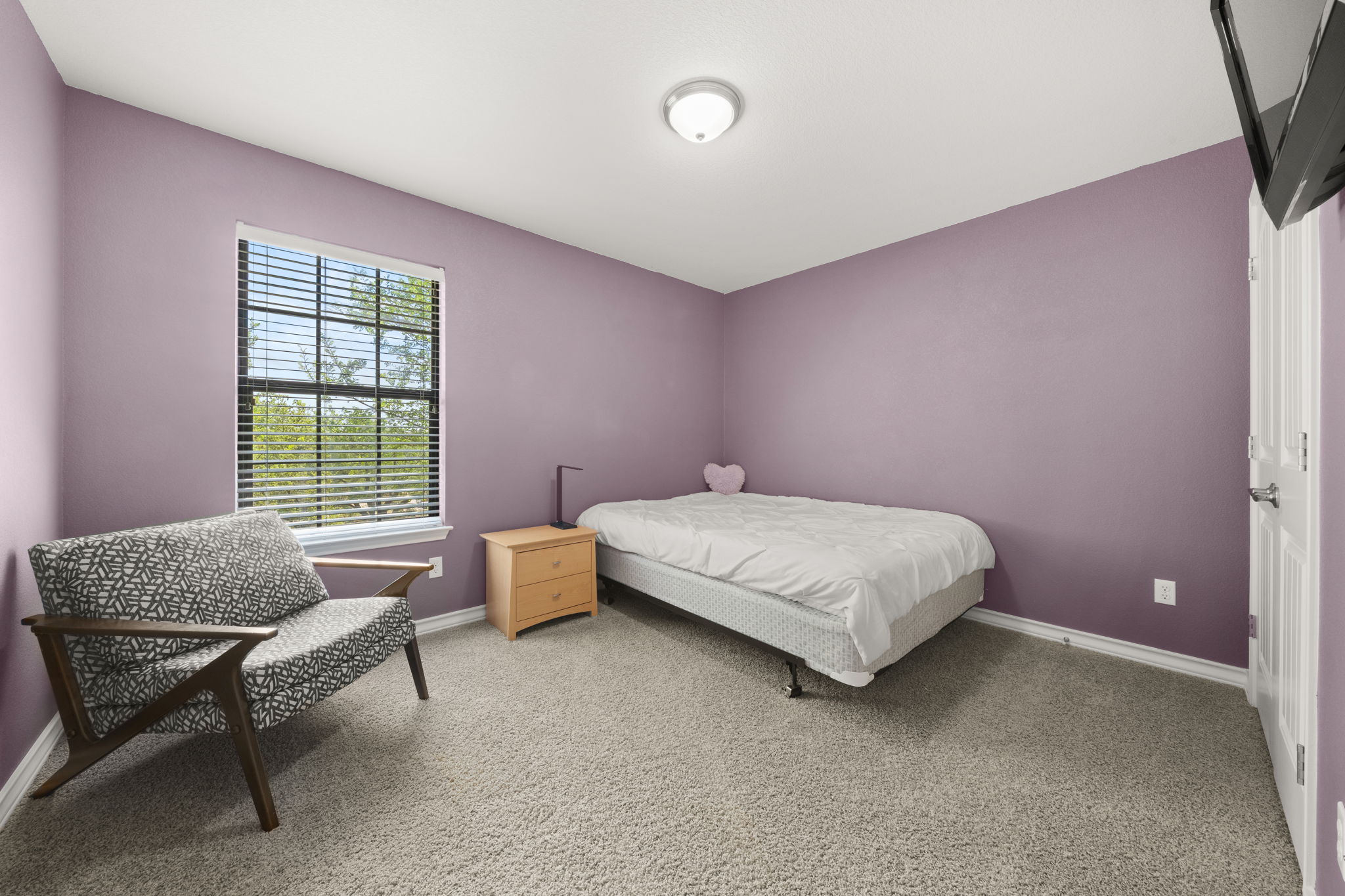 7629 Brecourt Manor Way Austin, TX 78739 - Photo 22 of 40 a bedroom with a bed and a window