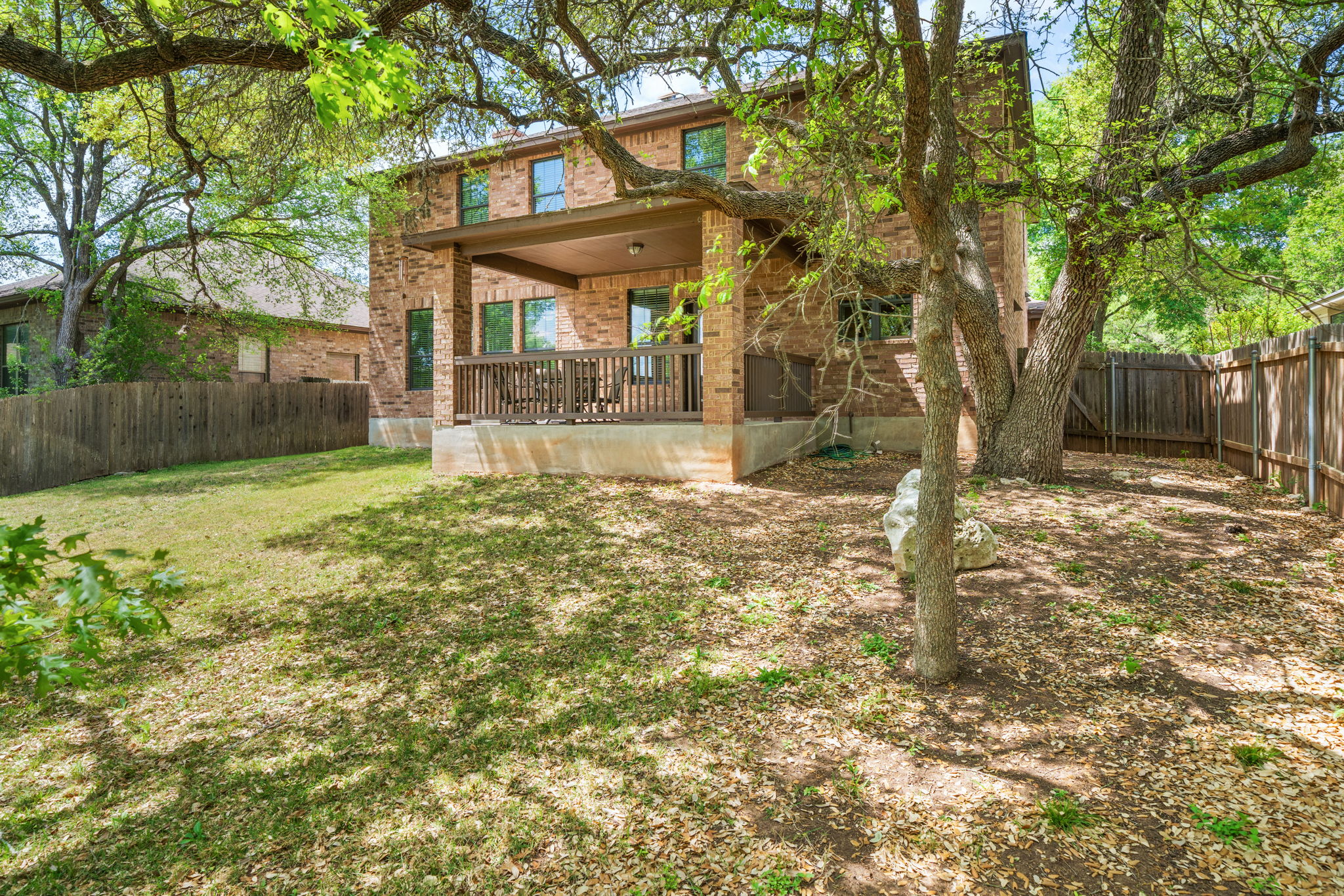 7629 Brecourt Manor Way Austin, TX 78739 - Photo 35 of 40 a view of a house with a yard