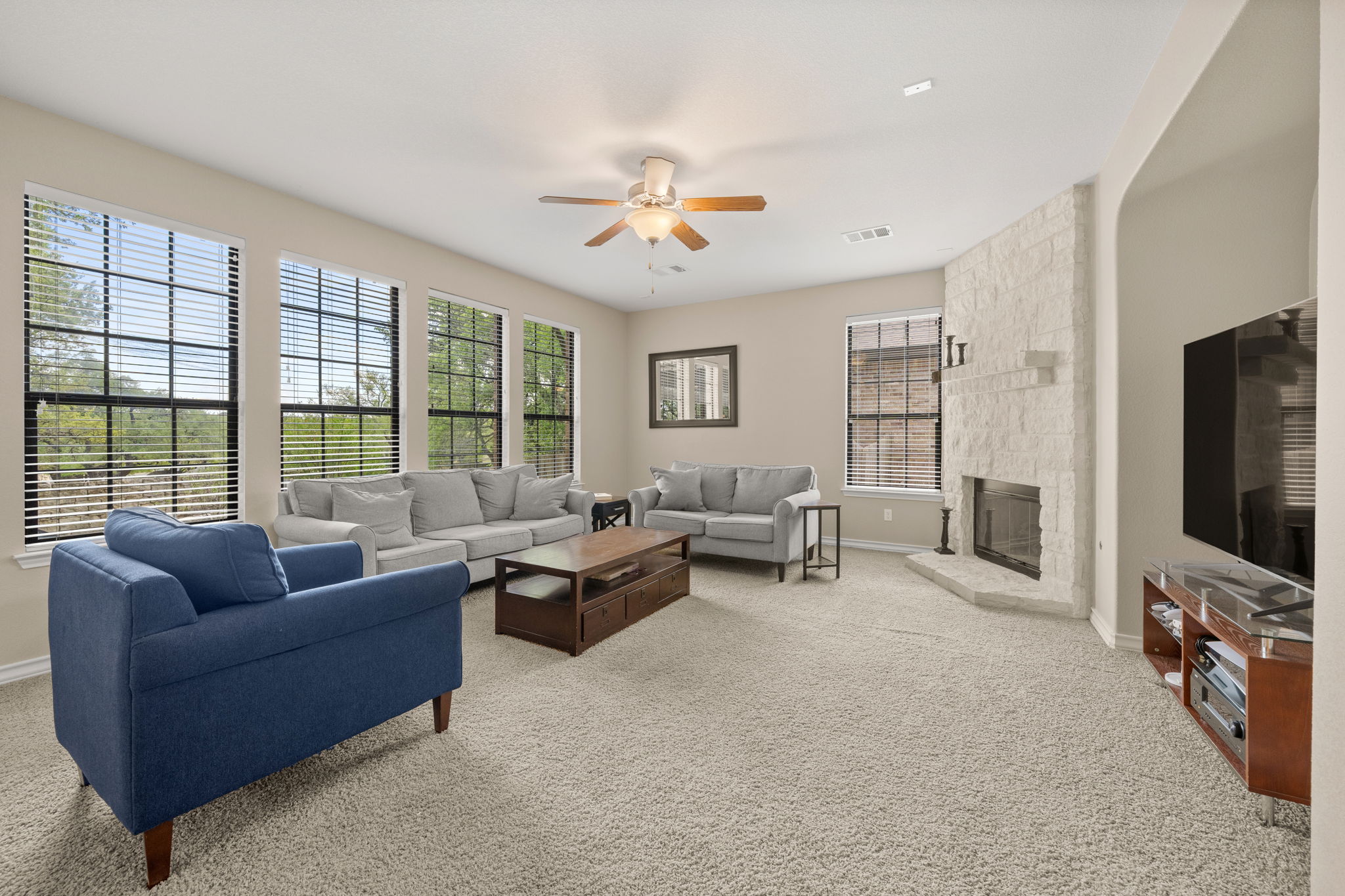 7629 Brecourt Manor Way Austin, TX 78739 - Photo 9 of 40 a living room with furniture a flat screen tv and a large window