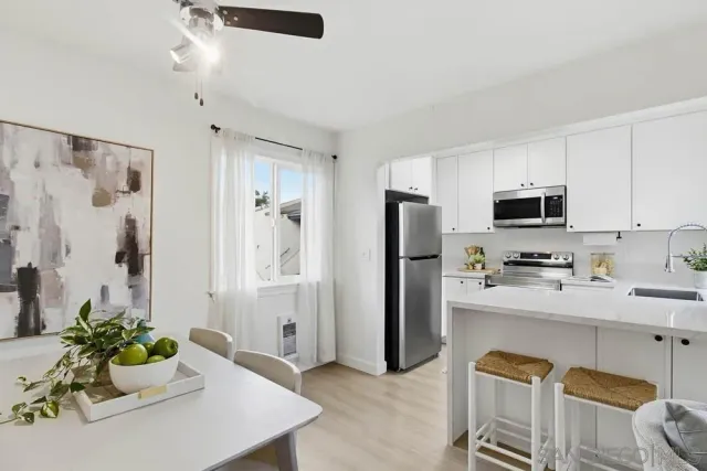 a kitchen with stainless steel appliances kitchen island granite countertop a refrigerator and microwave