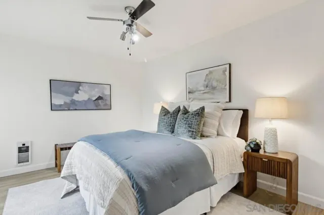 a bedroom with bed and painting on the wall