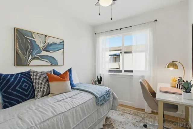 a bedroom with a bed and a desk