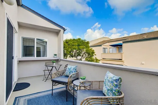 a balcony with furniture and wooden floor