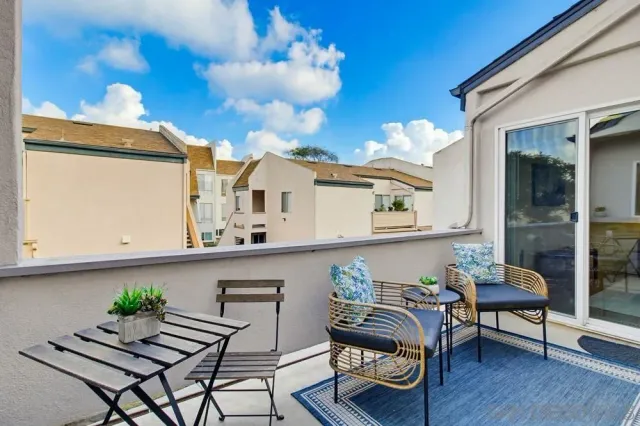 a balcony with furniture and a potted plant