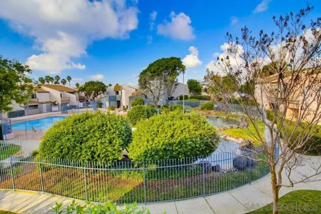 a view of swimming pool with outdoor seating and city view