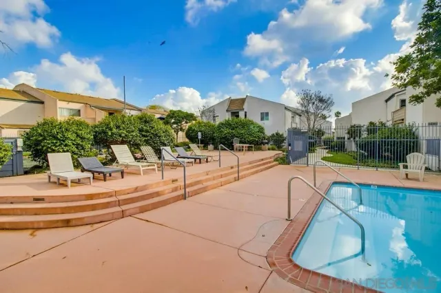 a view of a house with swimming pool and a yard