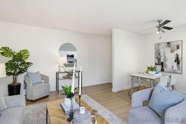 a living room with furniture flowerpot and wooden floor