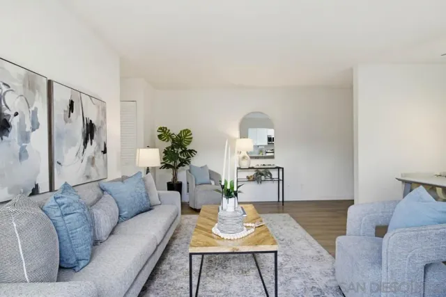 a living room with furniture and a potted plant