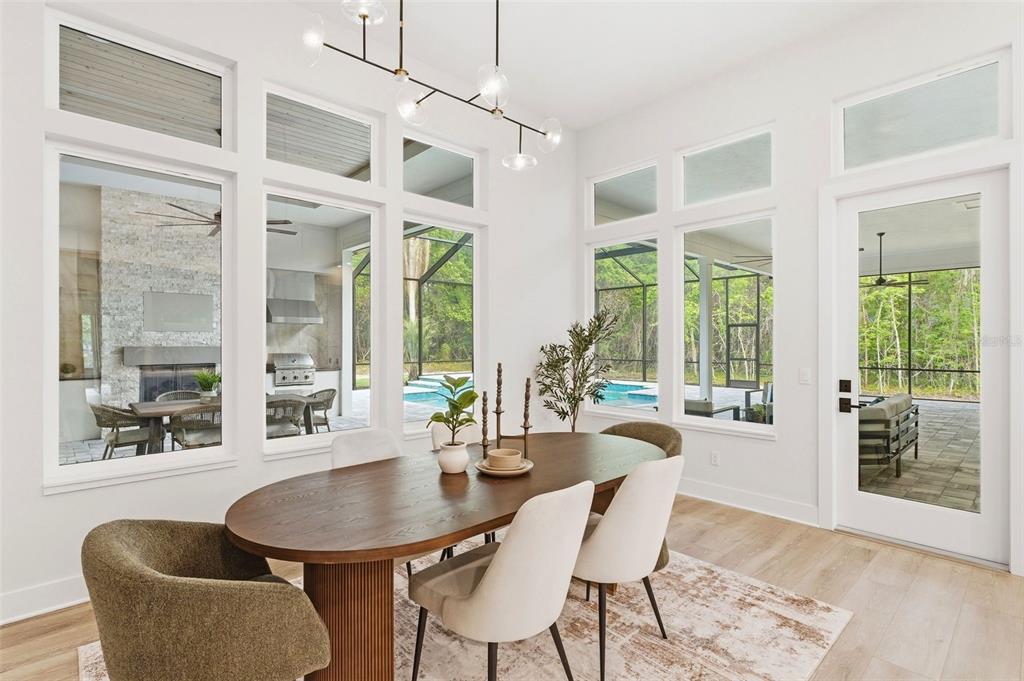 5995 Southwest 124th Way Archer, FL 32618 - Photo 12 of 33 a dining room with furniture large windows and wooden floor