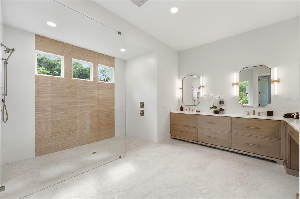 5995 Southwest 124th Way Archer, FL 32618 - Photo 16 of 33 a large bathroom with a large mirror vanity and shower