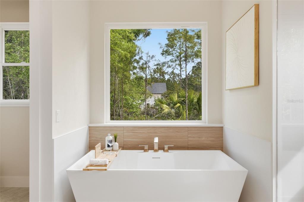 5995 Southwest 124th Way Archer, FL 32618 - Photo 22 of 33 a white bath tub sitting in a bathroom next to a window