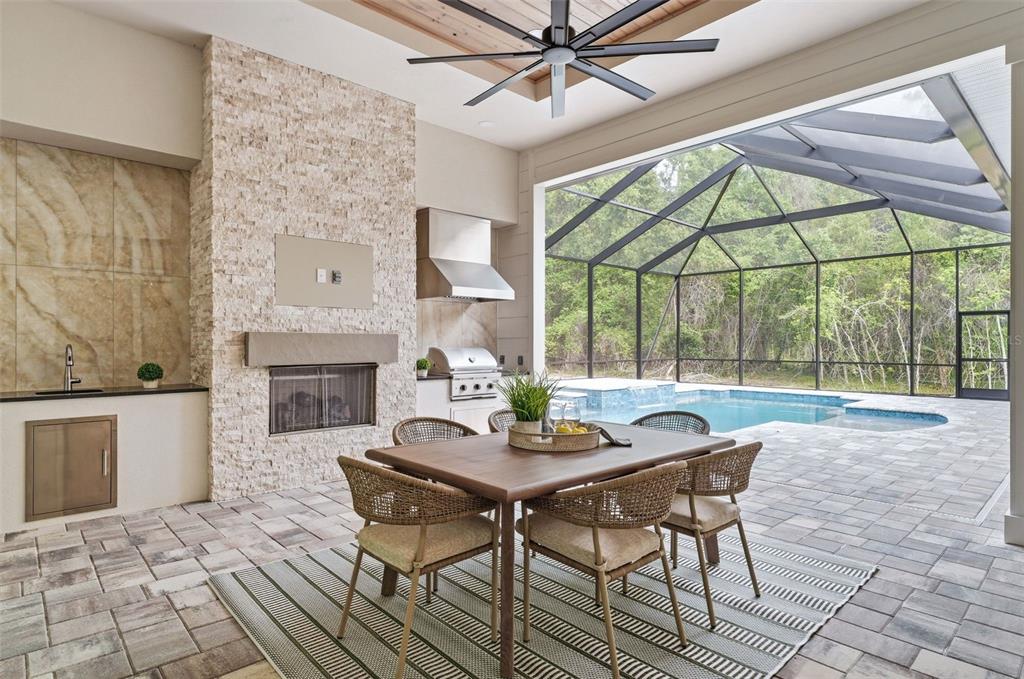5995 Southwest 124th Way Archer, FL 32618 - Photo 23 of 33 a dining room with furniture a fireplace and wooden floor