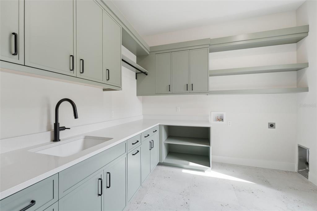 5995 Southwest 124th Way Archer, FL 32618 - Photo 27 of 33 a kitchen with white cabinets and a sink