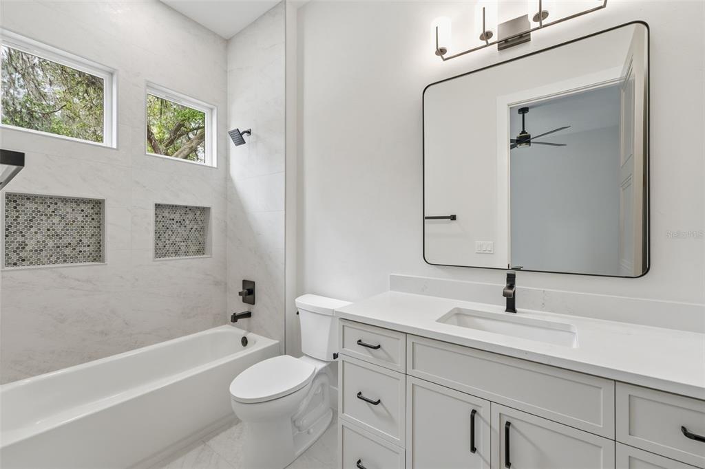 5995 Southwest 124th Way Archer, FL 32618 - Photo 31 of 33 a bathroom with a sink a toilet and shower