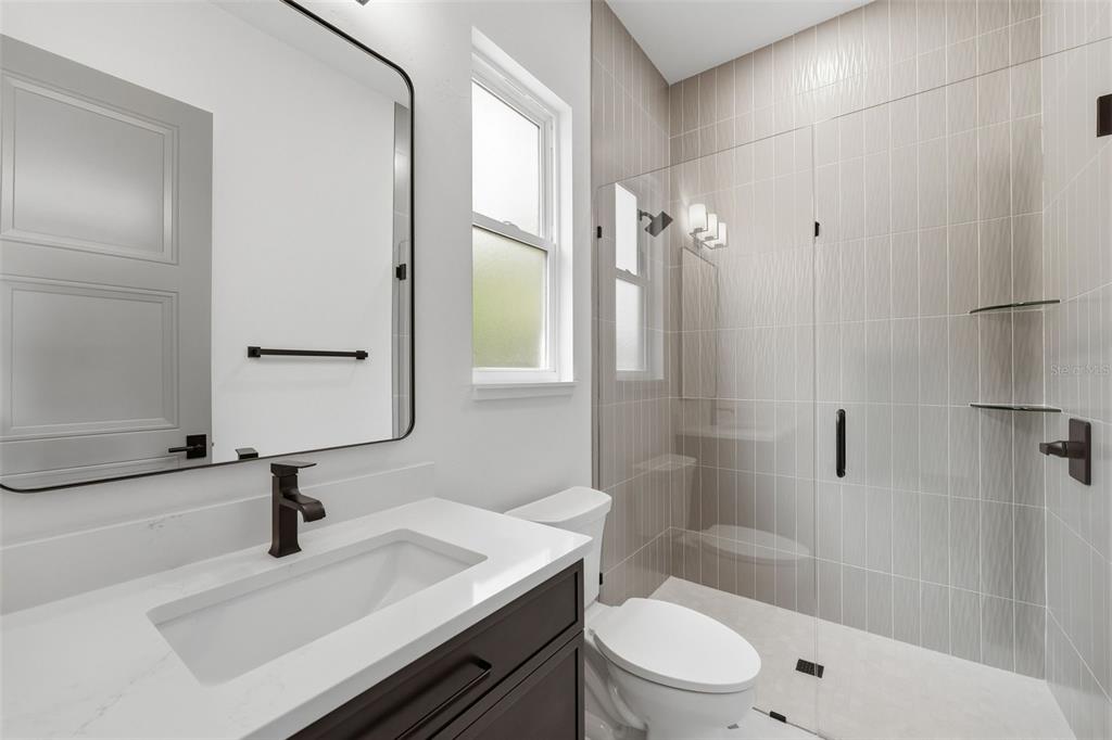 5995 Southwest 124th Way Archer, FL 32618 - Photo 32 of 33 a bathroom with a sink a toilet a mirror and shower