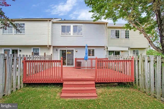 a front view of a house with garden and deck
