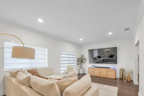 a living room with furniture and a large window
