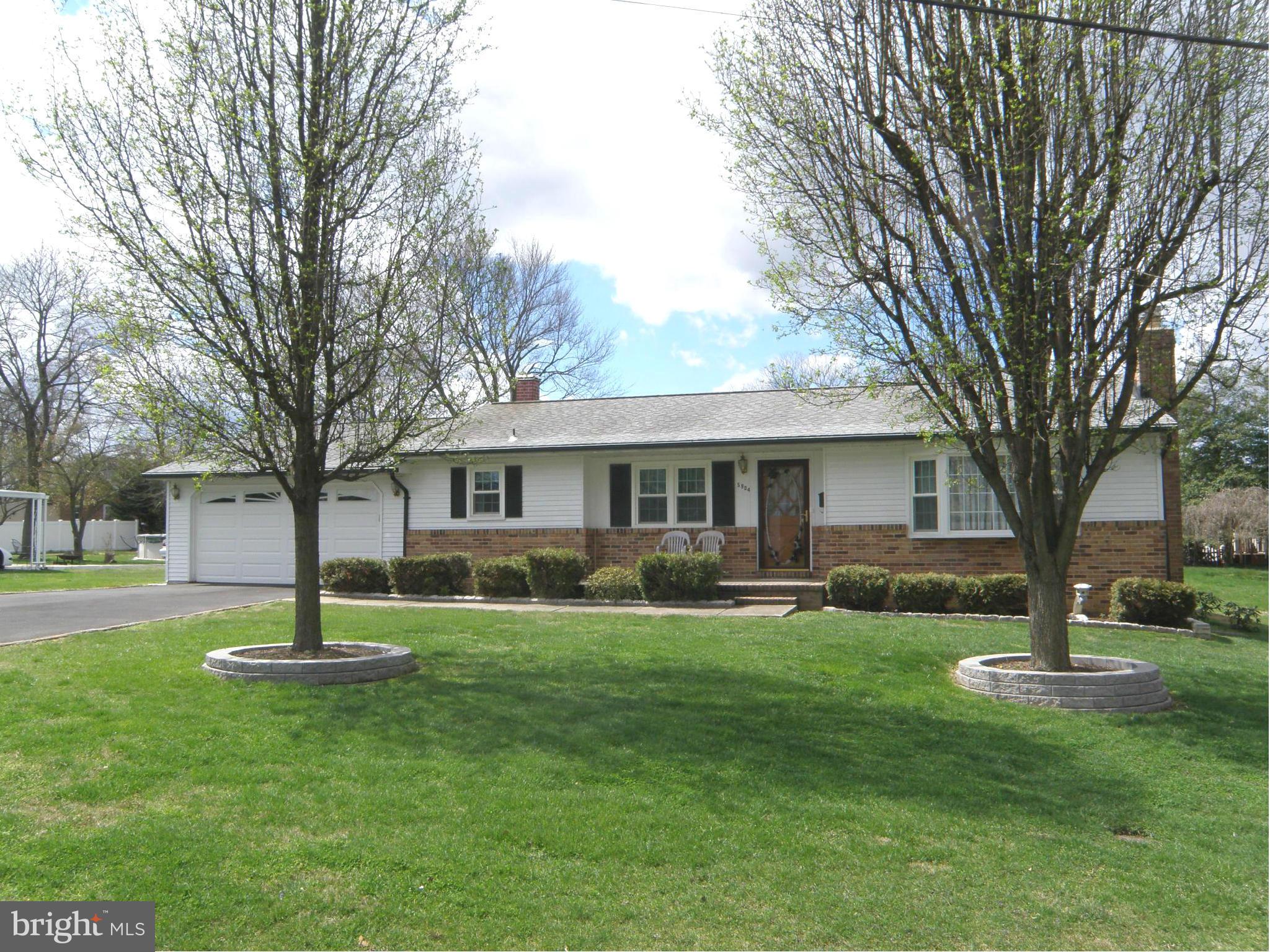 5904 Medora Road Linthicum Heights, MD 21090 - Photo 2 of 20 a front view of a house with a yard and trees