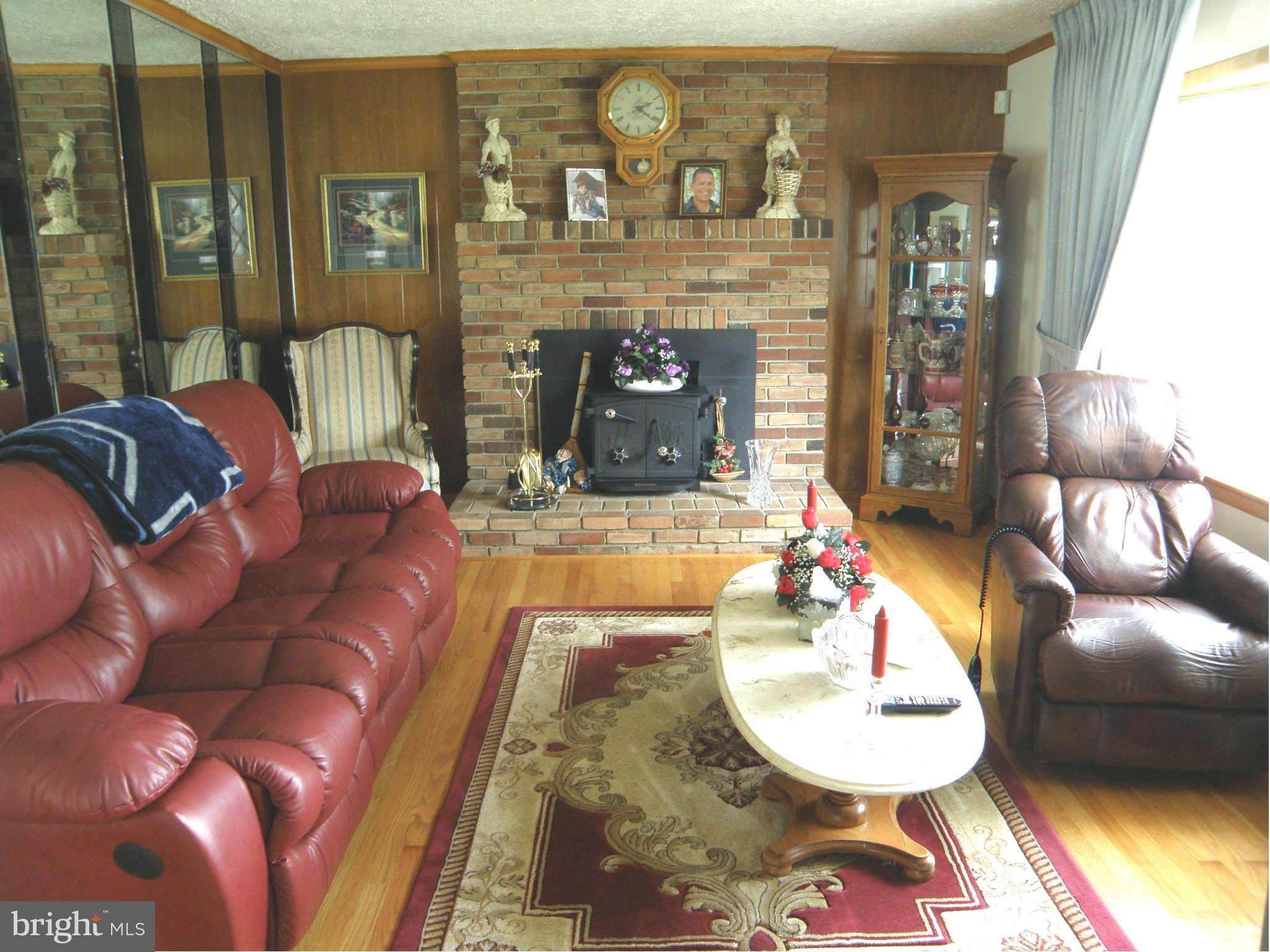 5904 Medora Road Linthicum Heights, MD 21090 - Photo 7 of 20 a living room with furniture and a fireplace