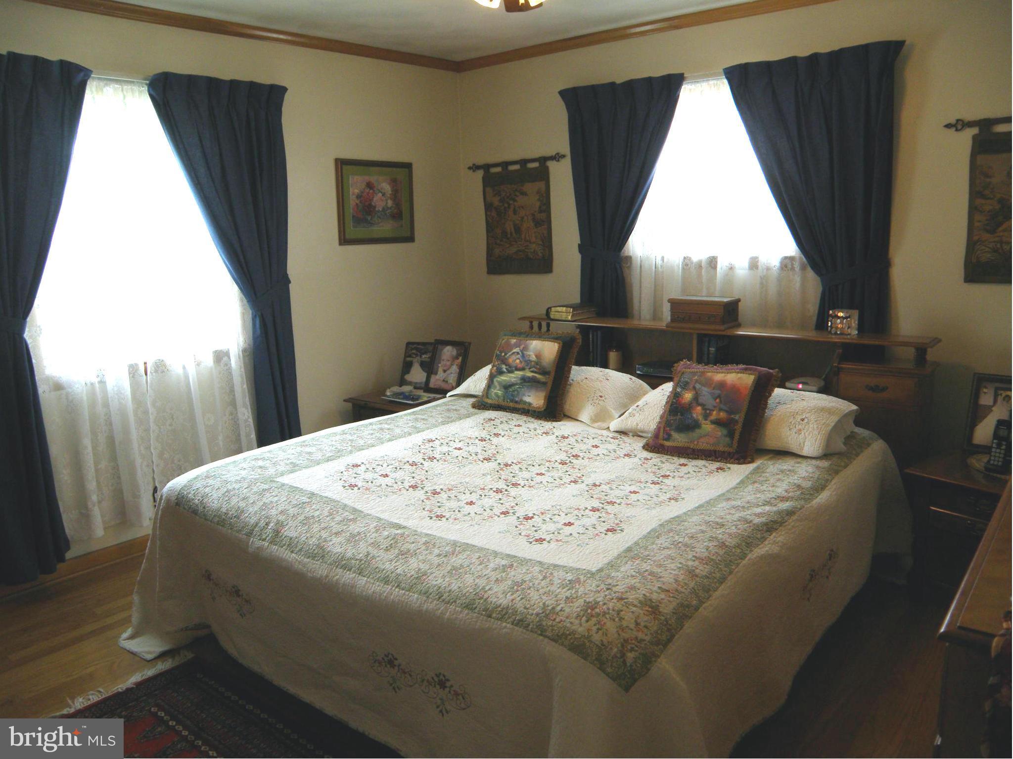 5904 Medora Road Linthicum Heights, MD 21090 - Photo 8 of 20 a bed sitting in a bedroom next to a window