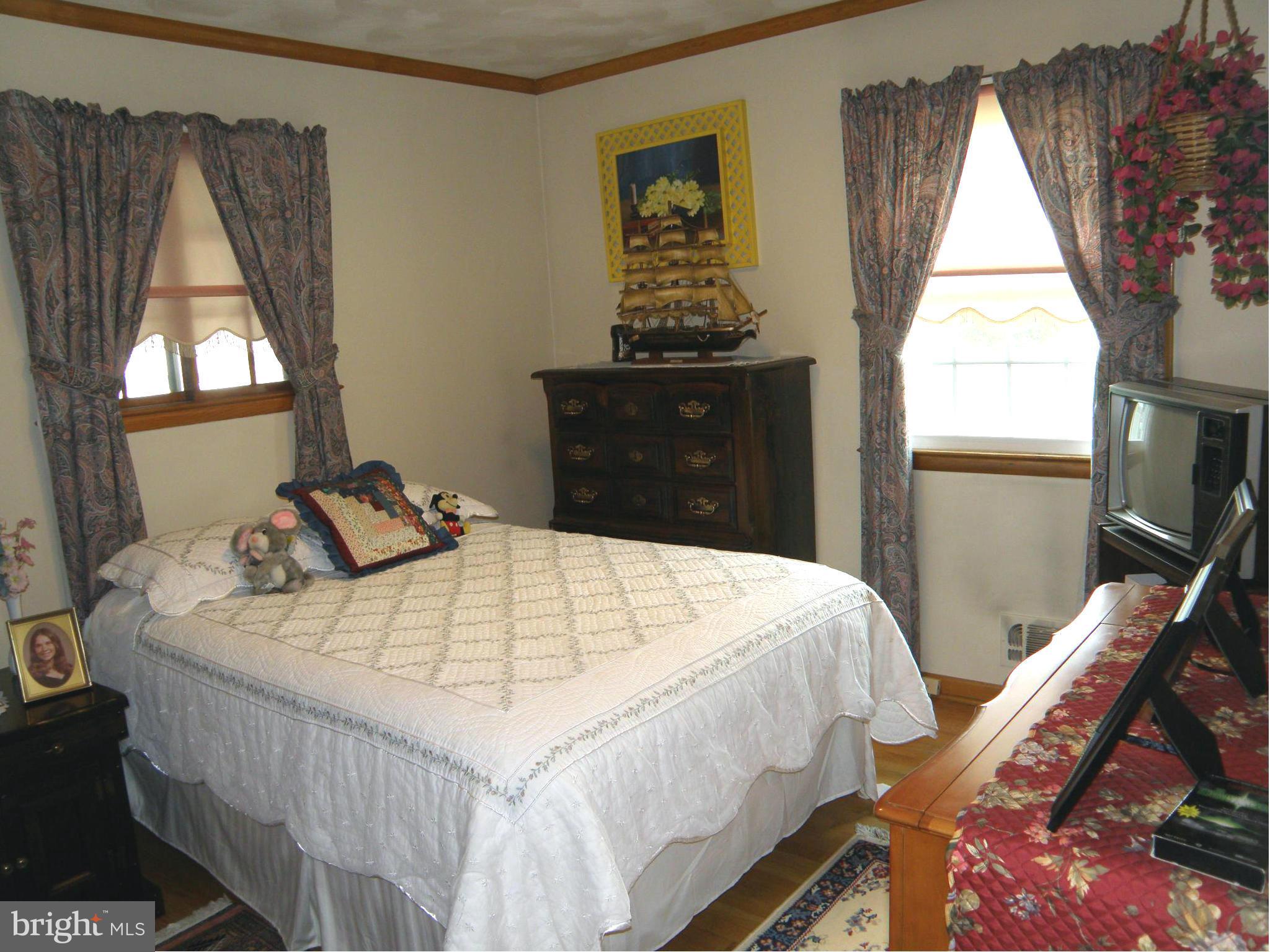 5904 Medora Road Linthicum Heights, MD 21090 - Photo 9 of 20 a bedroom with a bed and a window