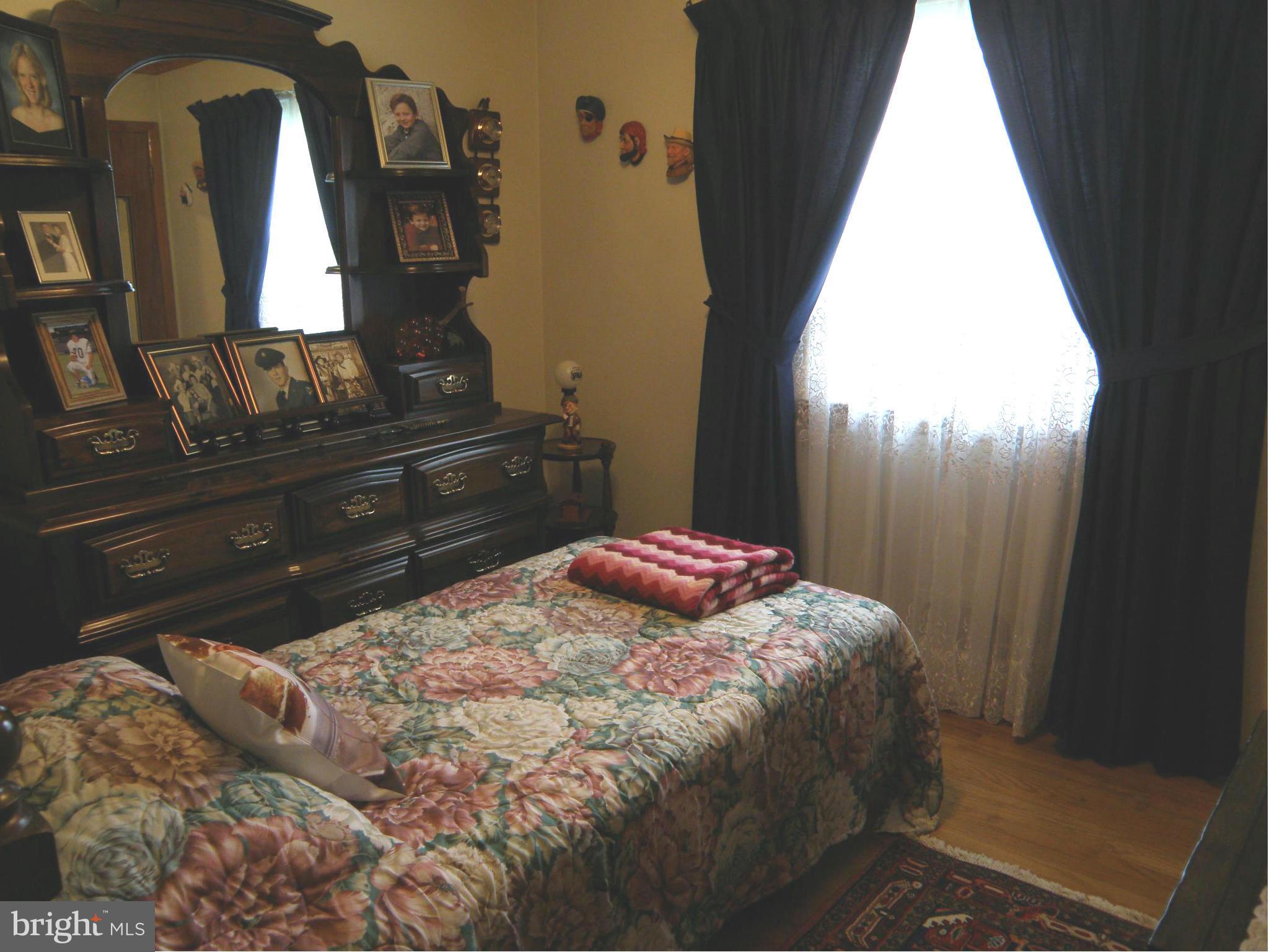 5904 Medora Road Linthicum Heights, MD 21090 - Photo 10 of 20 a bedroom with a bed and a dresser