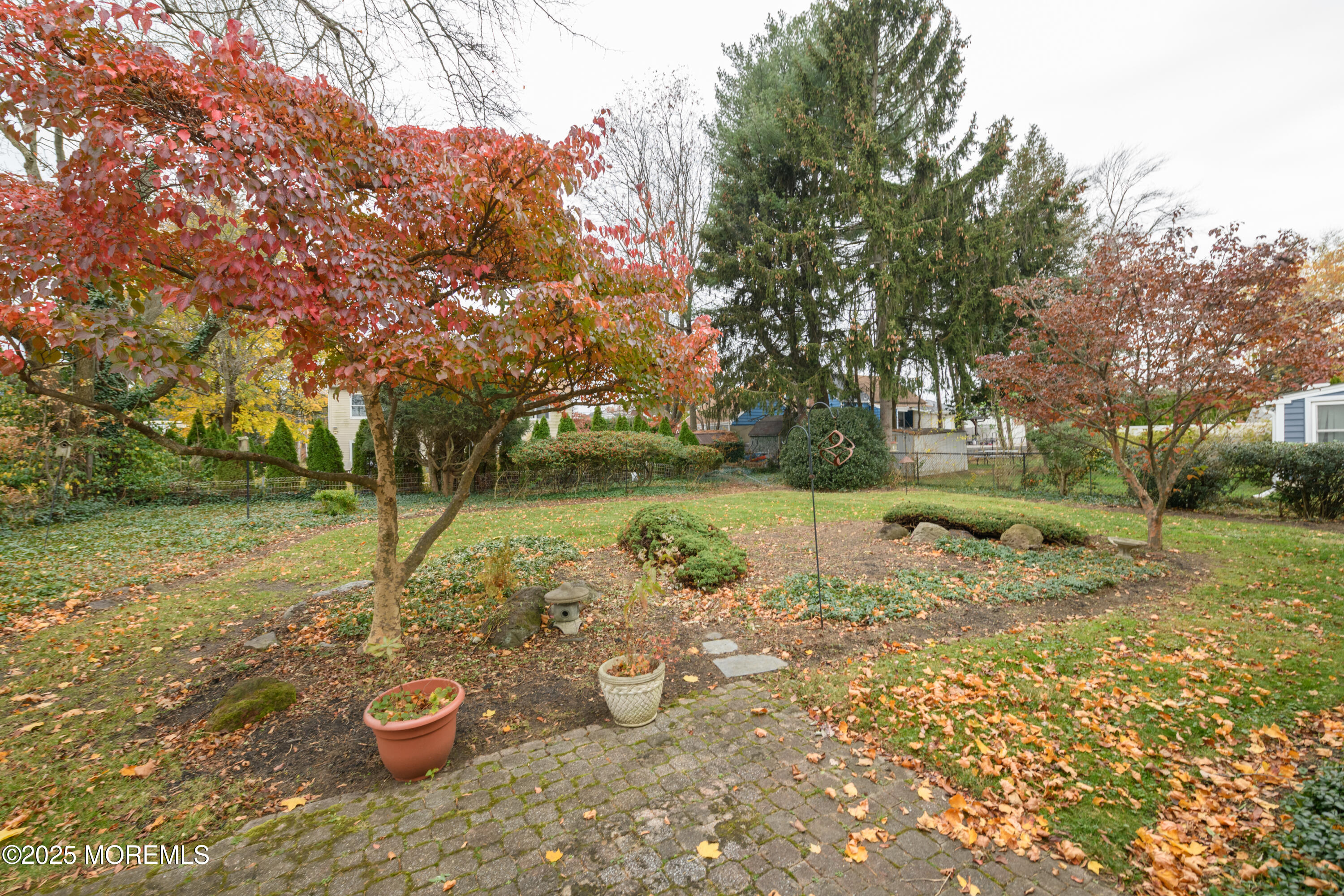 22 Overhill Road Matawan, NJ 07747 - Photo 25 of 27 a view of a backyard with fountain and plants