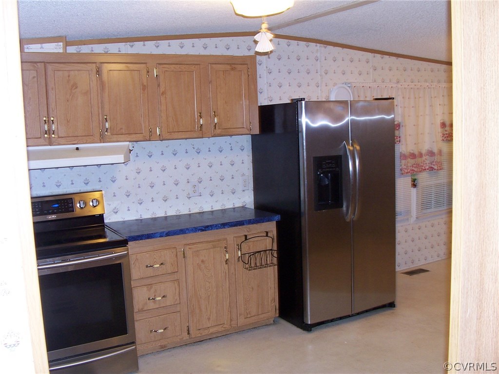 6775 Hair Road Disputanta, VA 23842 - Photo 3 of 10 a kitchen with stainless steel appliances granite countertop a refrigerator and a stove